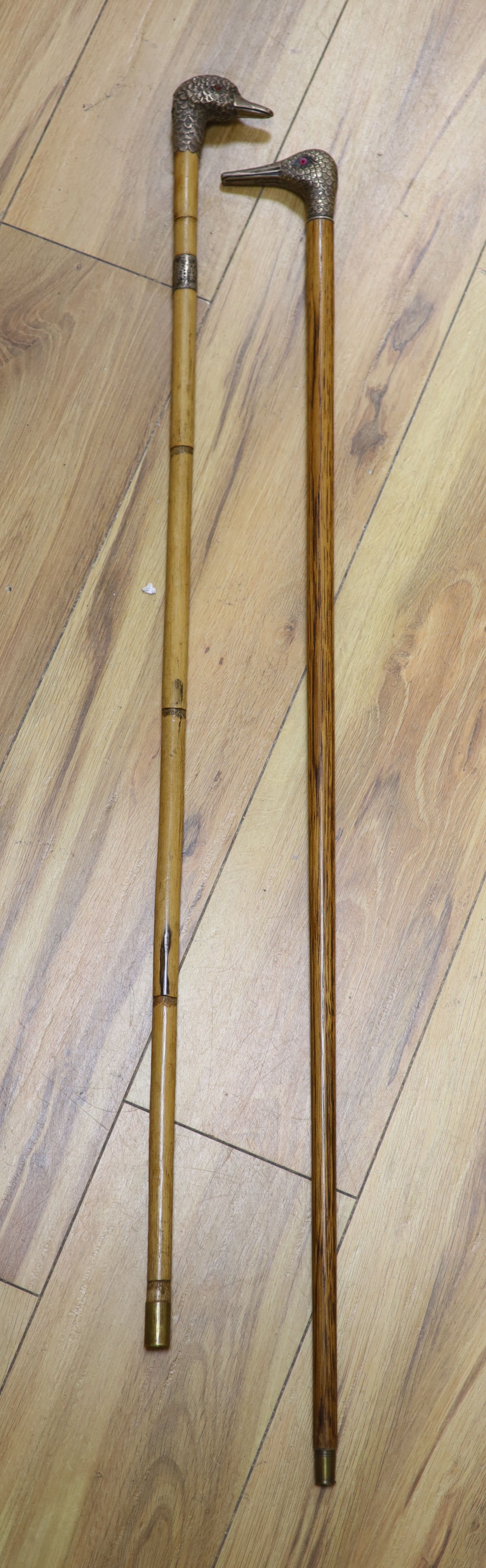 A Victorian silver mounted duck head cane, London 1899 and a white metal mounted dove head cane